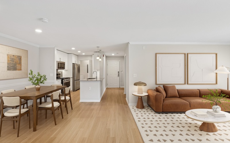 a living room with a couch, dining table and chairs