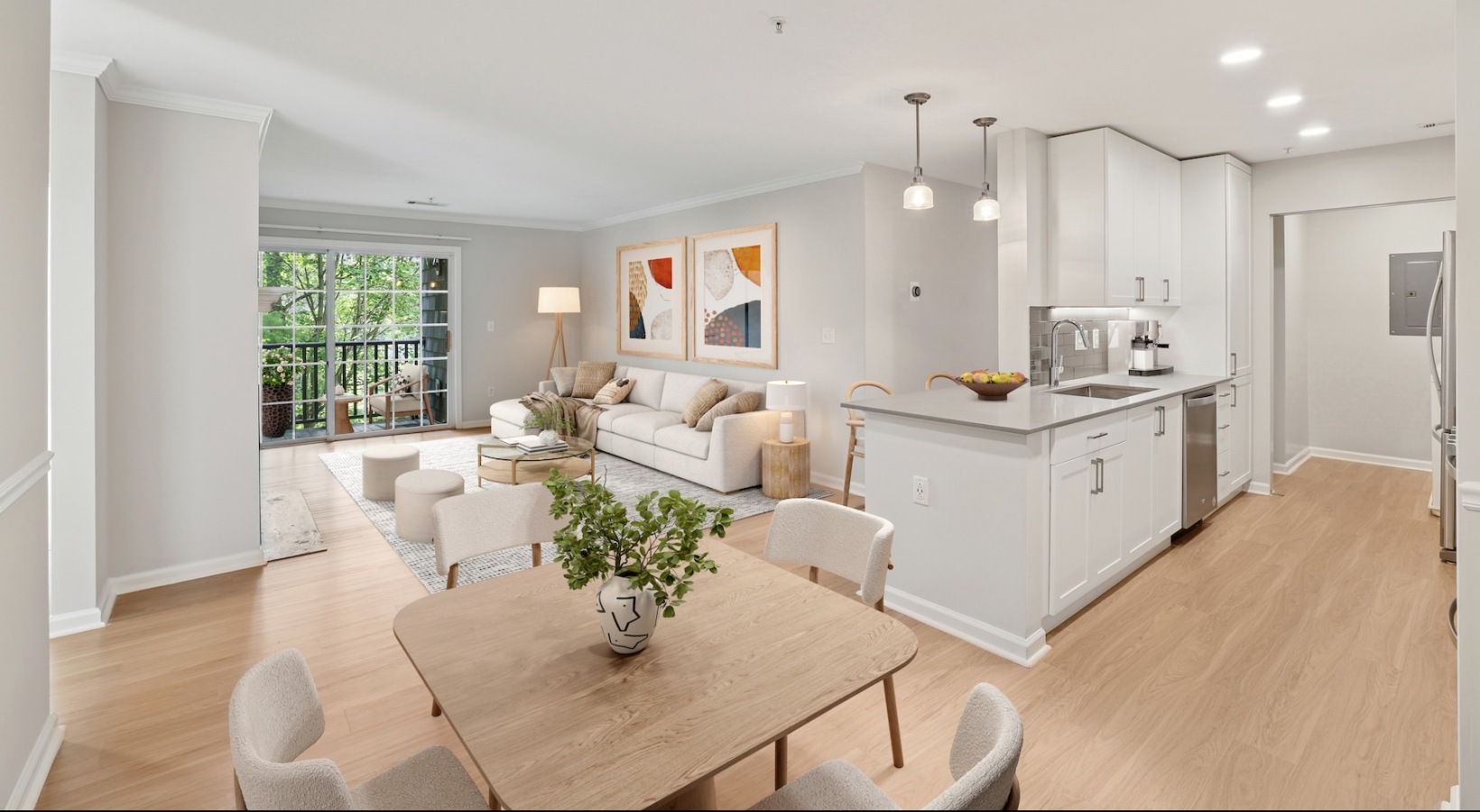 a living room and kitchen with a dining table and chairs