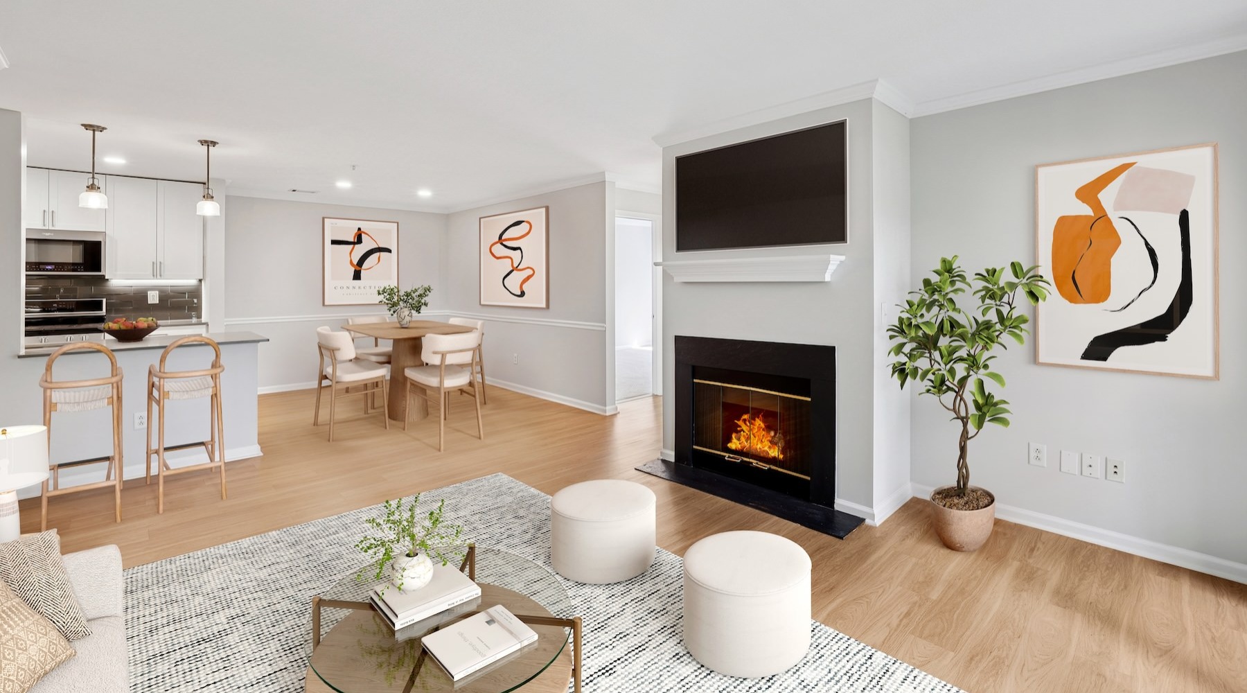 a living room with a tv, fireplace and a coffee table