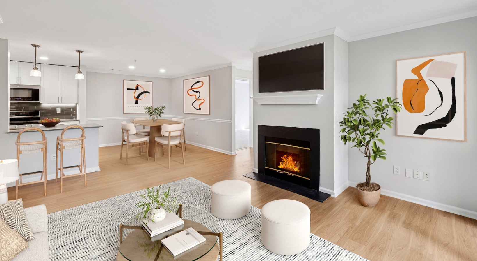 a living room with a tv, fireplace and a coffee table