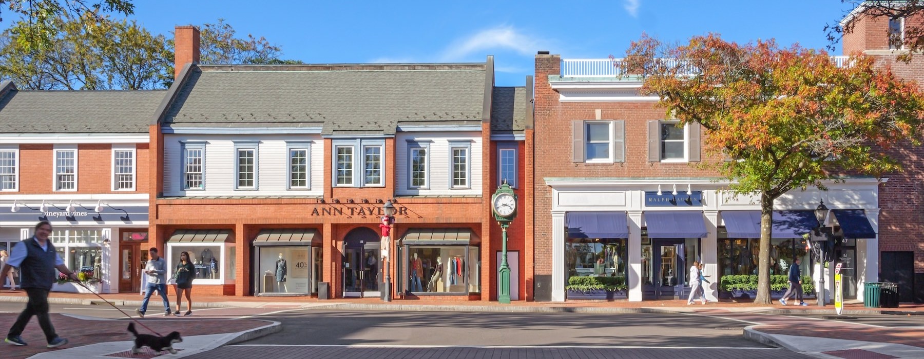 people walking in a street in front of buildings